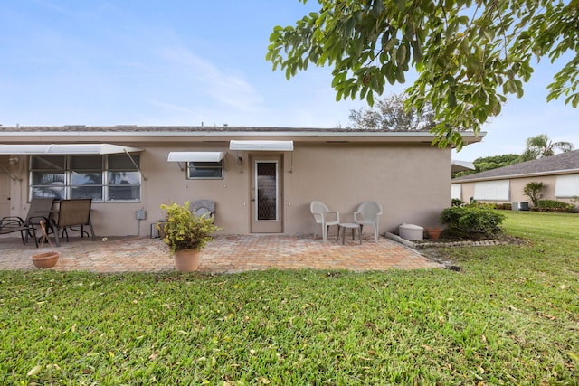 back of house with a patio and a yard