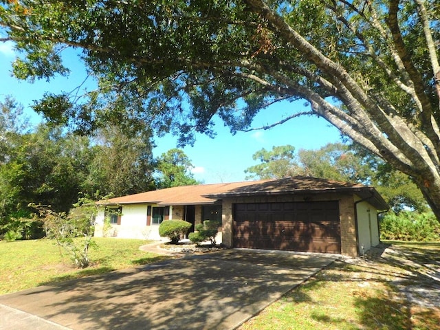 ranch-style home with a front lawn and a garage