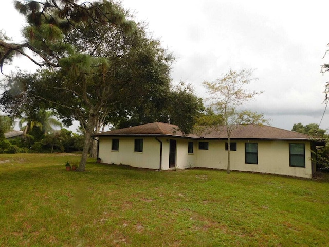 rear view of house with a yard