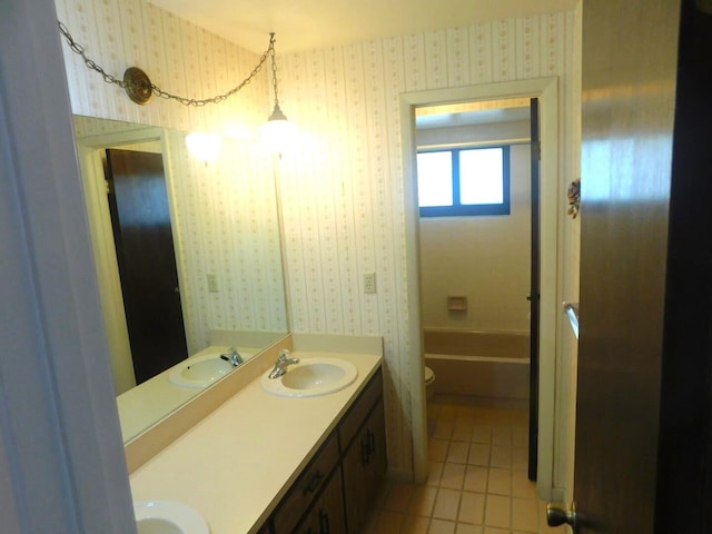 bathroom with tile patterned flooring, vanity, and toilet