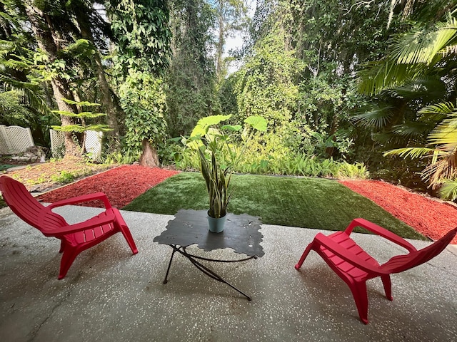 view of property's community featuring a yard and a patio area