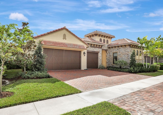 mediterranean / spanish-style house with a front yard and a garage