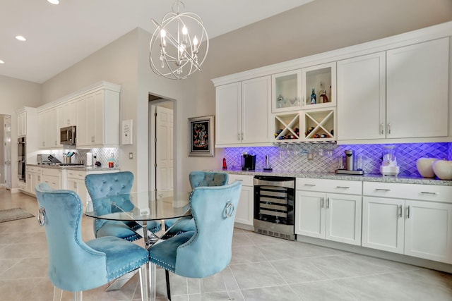 interior space featuring wine cooler, light tile patterned floors, and a chandelier