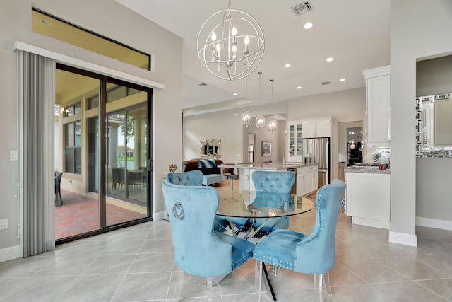 tiled dining area featuring sink and a notable chandelier