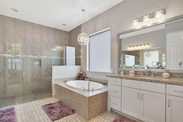 bathroom featuring vanity and independent shower and bath