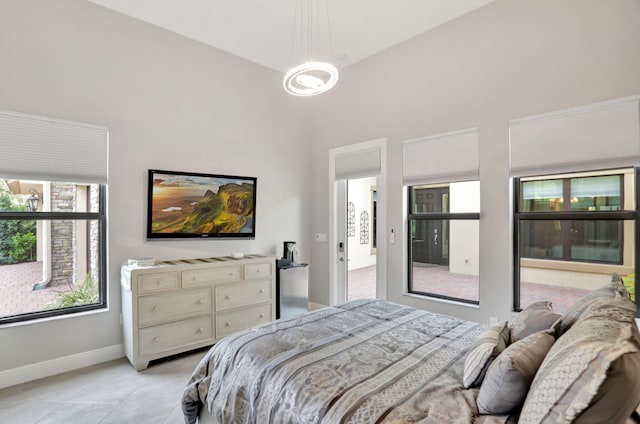 bedroom with light tile patterned floors and a towering ceiling