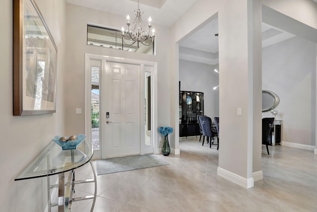 tiled entryway featuring an inviting chandelier