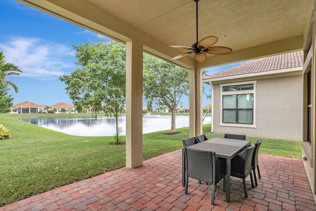 view of patio / terrace with ceiling fan and a water view