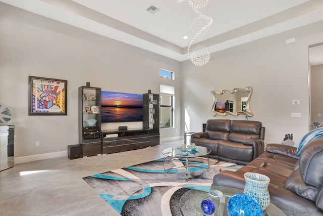 living room featuring light tile patterned floors and an inviting chandelier