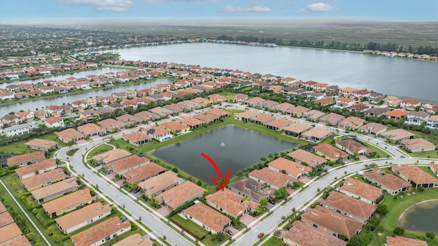 birds eye view of property with a water view