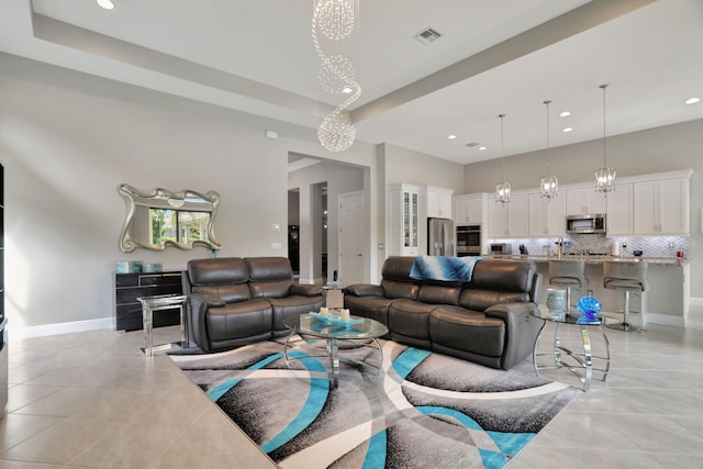 tiled living room with a chandelier