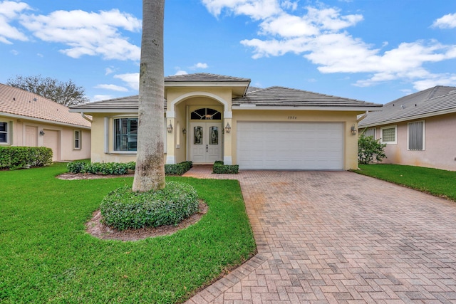 view of front of house with a garage and a front yard