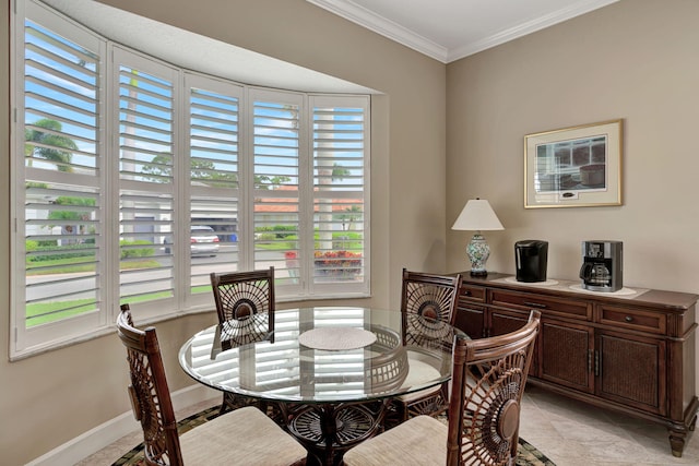 tiled dining room featuring ornamental molding