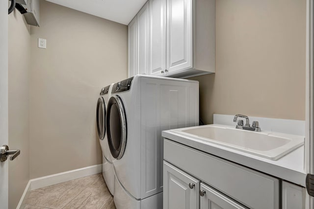 clothes washing area featuring cabinets, sink, light tile patterned floors, and independent washer and dryer