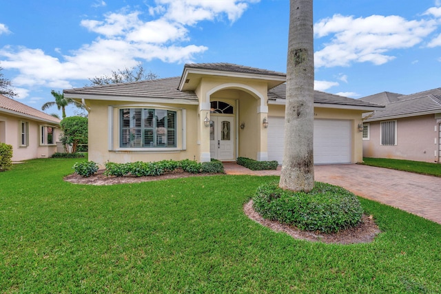 view of front facade with a front yard and a garage