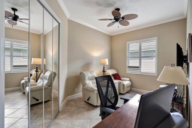 home office with crown molding, ceiling fan, and light tile patterned flooring