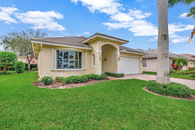 view of front of house with a garage and a front lawn