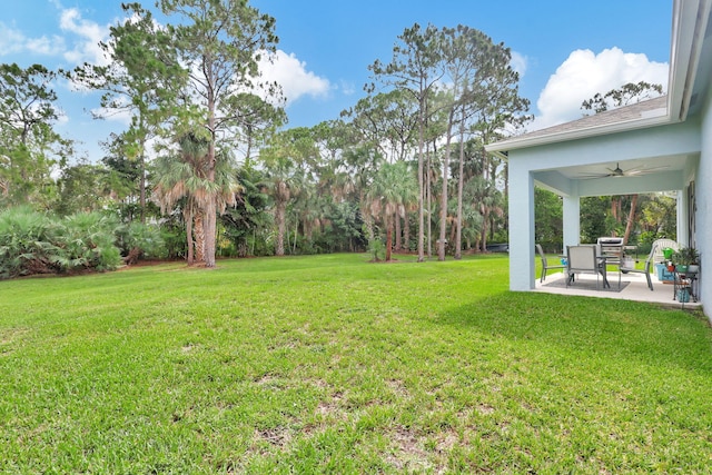 view of yard with a patio area and ceiling fan