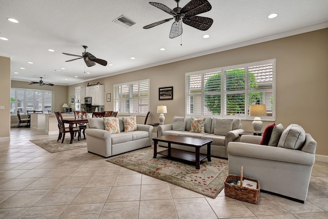 tiled living room featuring crown molding and ceiling fan