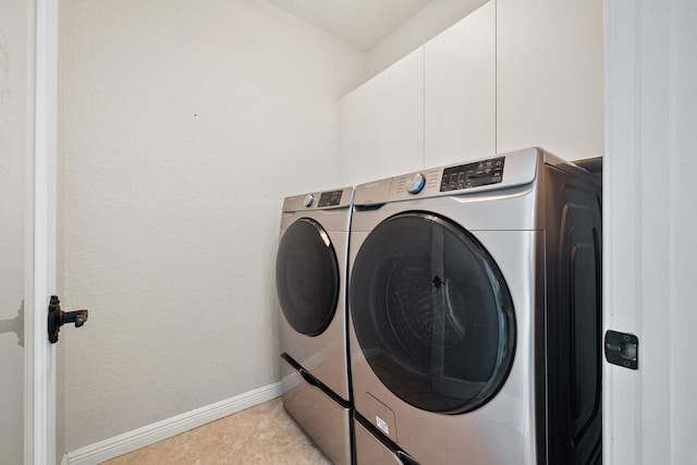 washroom featuring separate washer and dryer and light tile patterned floors