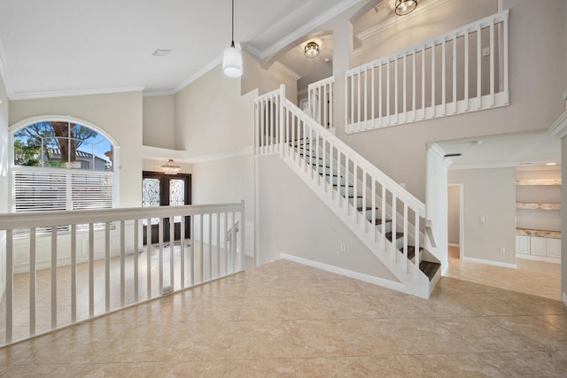 stairway with crown molding, tile patterned floors, and a high ceiling