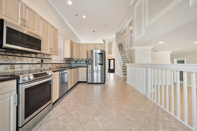 kitchen featuring crown molding, tasteful backsplash, stainless steel appliances, and sink