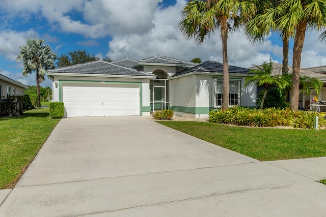 view of front of property featuring a front yard and a garage