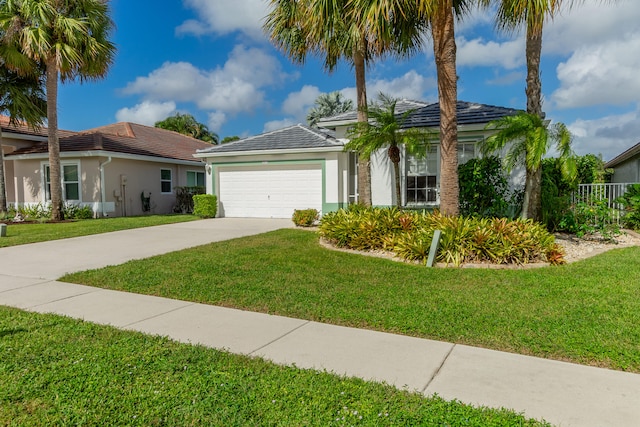 view of front of property with a front yard and a garage