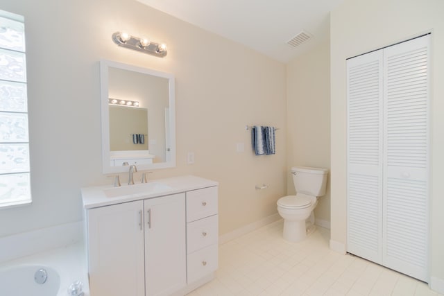 bathroom with vanity, toilet, plenty of natural light, and a bathing tub