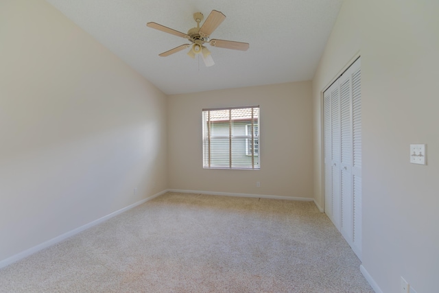 unfurnished bedroom with light colored carpet, a closet, and ceiling fan