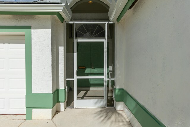 doorway to property with a garage