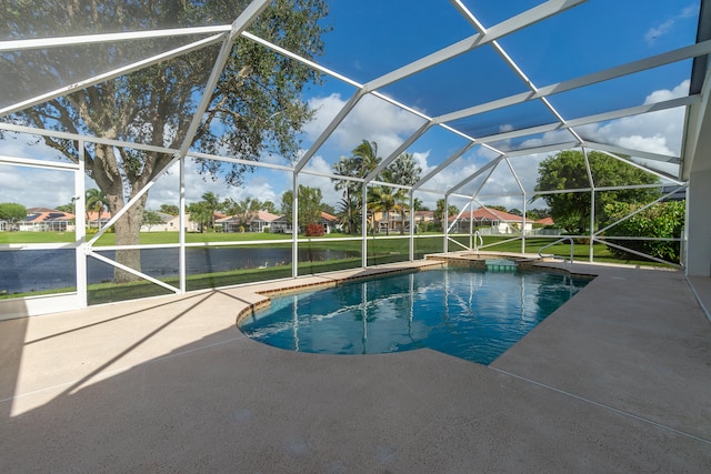 view of swimming pool with a patio area, a lanai, and a water view