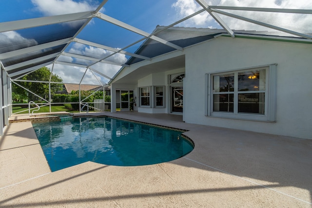 view of swimming pool with a patio and glass enclosure