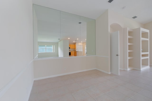 empty room with light tile patterned floors