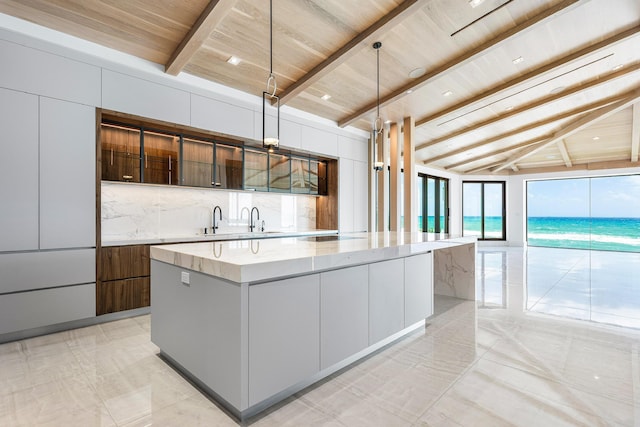 kitchen with backsplash, wood ceiling, a kitchen island, a sink, and modern cabinets