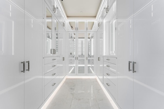 walk in closet with marble finish floor