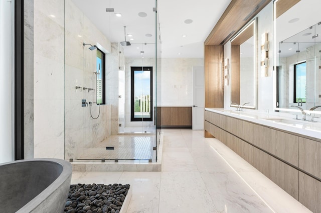 full bathroom featuring a shower stall, a soaking tub, marble finish floor, a sink, and double vanity