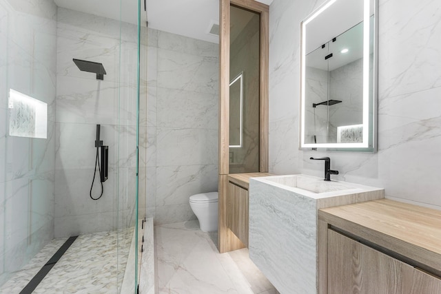 bathroom with marble finish floor, toilet, and a marble finish shower