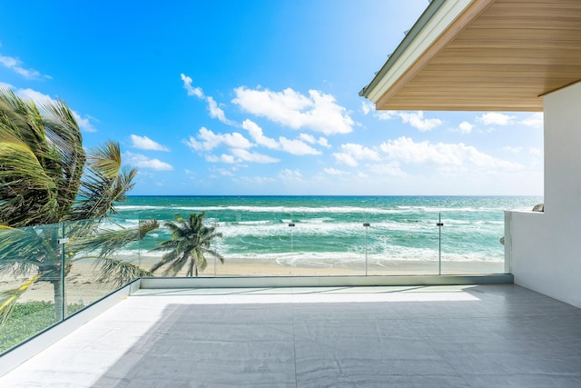 balcony with a view of the beach and a water view
