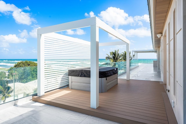 exterior space with a water view and a hot tub