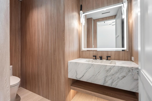 half bathroom with toilet and a sink