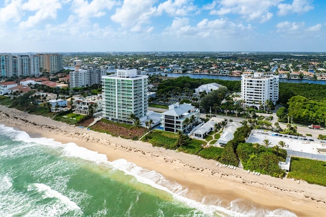 birds eye view of property with a beach view, a water view, and a city view
