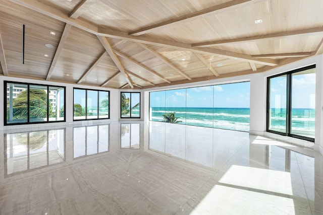 unfurnished sunroom featuring a water view and beam ceiling
