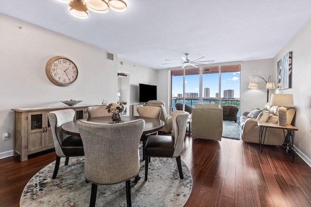 dining space with ceiling fan, floor to ceiling windows, and dark hardwood / wood-style flooring