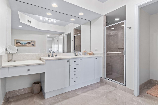 bathroom featuring vanity and a shower with door