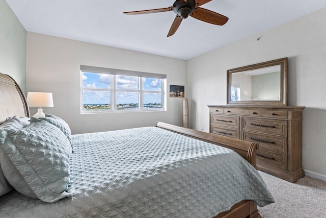 bedroom featuring light carpet and ceiling fan