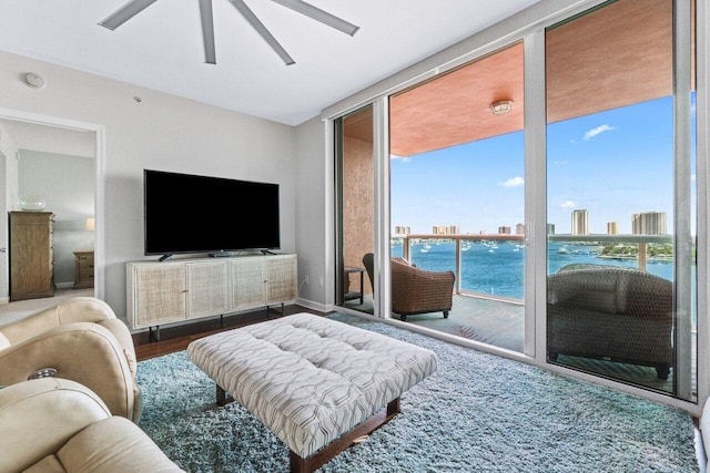 living room with floor to ceiling windows, hardwood / wood-style flooring, and ceiling fan