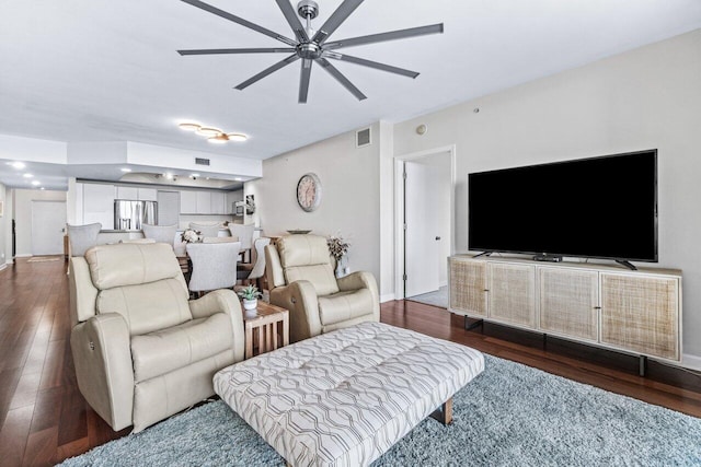 living room featuring dark hardwood / wood-style flooring and ceiling fan