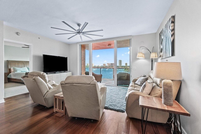 living room with ceiling fan and dark hardwood / wood-style floors