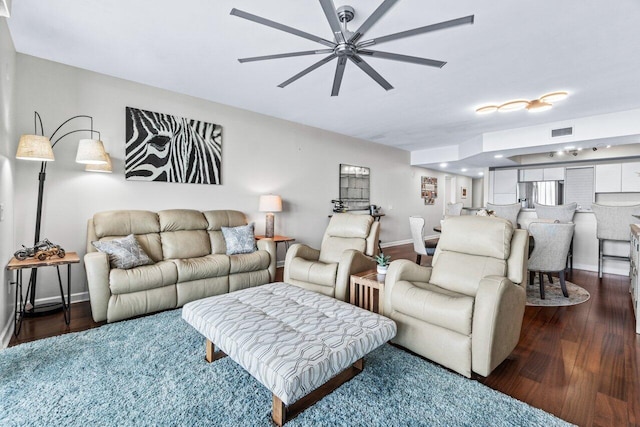 living room featuring dark hardwood / wood-style floors and ceiling fan